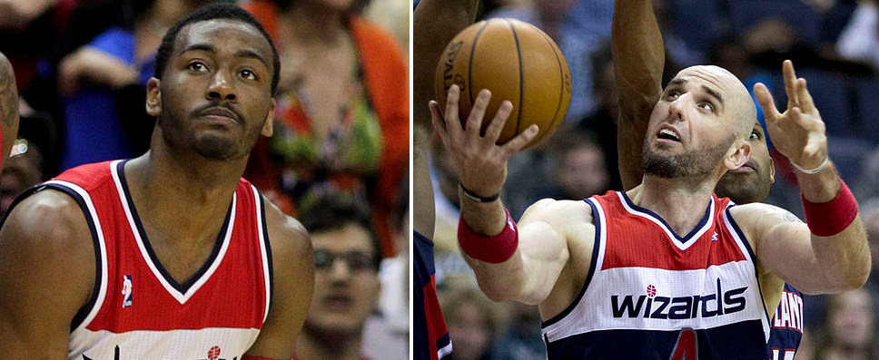 Smiling young woman with blonde hair in front of a textured wall.