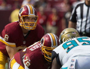 Two Washington football players preparing for a play against the Jaguars.