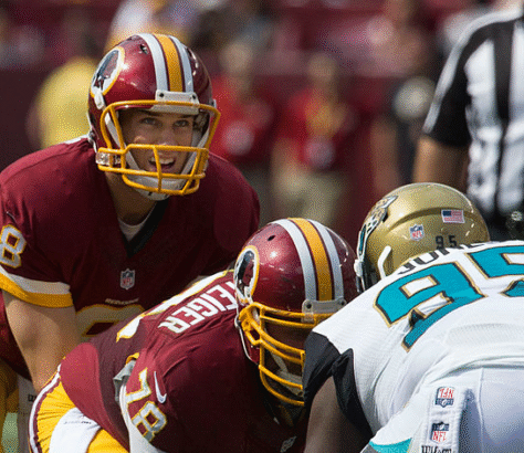 Two Washington football players preparing for a play against the Jaguars.