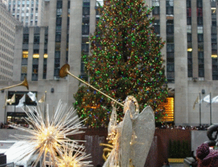 Rockefeller Center Christmas tree with angel and star decorations.