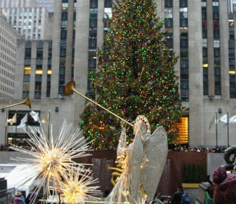 Rockefeller Center Christmas tree with angel and star decorations.