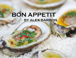 Close-up of fresh oysters on ice with vibrant garnish.
