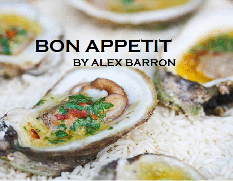 Close-up of fresh oysters on ice with vibrant garnish.