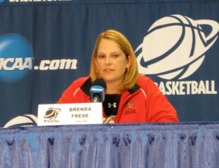 Woman speaking at a basketball press conference.