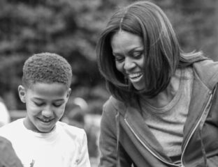 A joyful woman and boy sharing a moment outdoors.