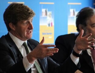 Two men in suits engaged in a serious discussion.