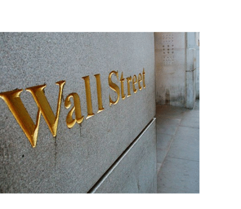 Wall Street sign engraved in gold on a stone wall.