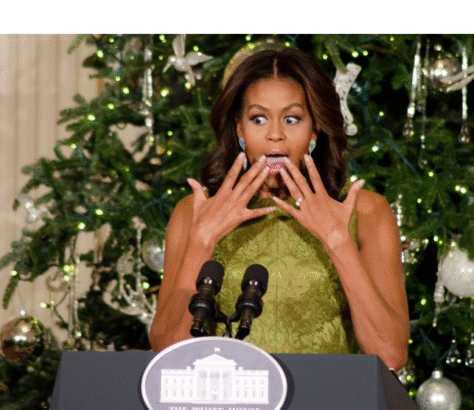 Michelle Obama surprised and joyful in front of a Christmas tree at the White House.