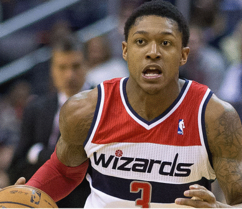 Basketball player in a Wizards jersey focused during a game.