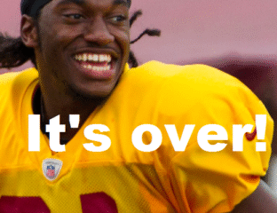 Football player smiling during practice.