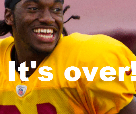 Football player smiling during practice.
