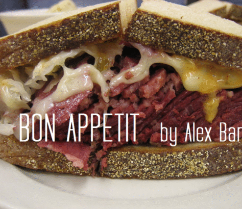Close-up of a pastrami sandwich with rye bread and melted cheese.