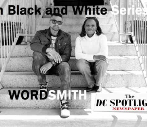 Two stylish individuals sitting on stairs in a black and white photo.