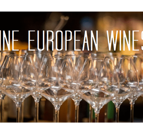 Rows of empty wine glasses ready for a European wine tasting event.