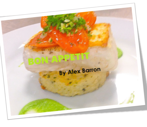 Grilled fish fillet with garnish and lime on white plate.