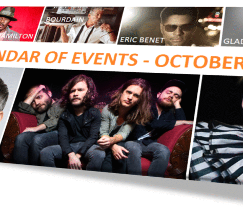 Rock band posing together in a promotional photo with event banner above.