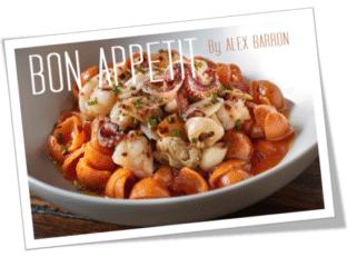 Delicious pasta with tomato sauce, topped with nuts and herbs.