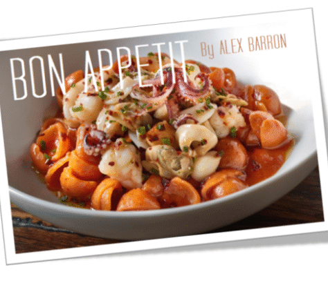 Delicious pasta with tomato sauce, topped with nuts and herbs.