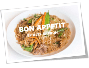 A hearty dish of pulled meat with fresh carrots and herbs.