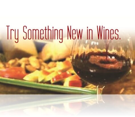 A glass of red wine with food and the text encouraging trying new wines.