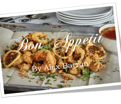 Delicious golden-brown baked pastries garnished with herbs on a white platter.