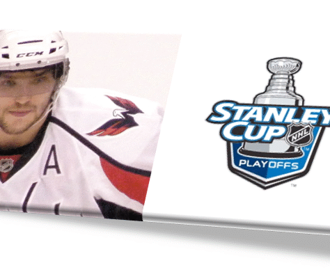 Hockey player in white jersey with Stanley Cup Playoffs logo.