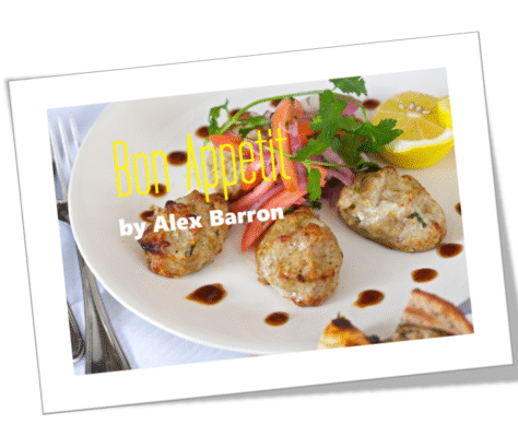 Delicious roasted chicken drumsticks garnished with fresh herbs and lemon slices.