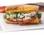 A delicious sandwich with melted cheese and fresh greens on a crusty baguette.