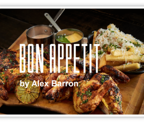 Delicious grilled chicken served with rice, fries, and sauces on a wooden platter.