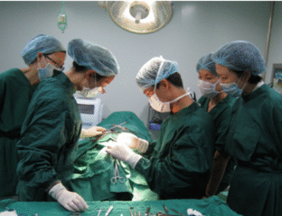 A surgical team performing an operation in a sterile environment.