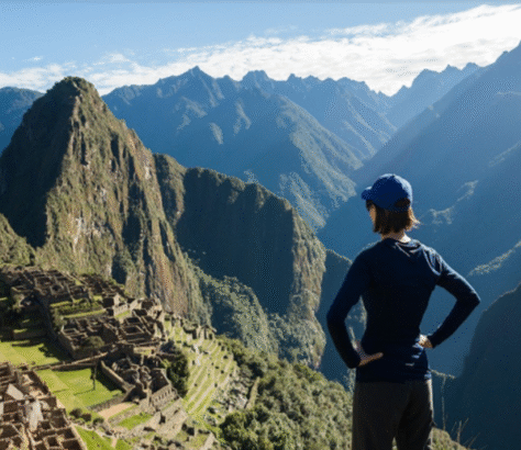Person admiring the ancient ruins of Machu Picchu at sunrise.