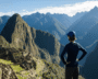 Person admiring the ancient ruins of Machu Picchu at sunrise.