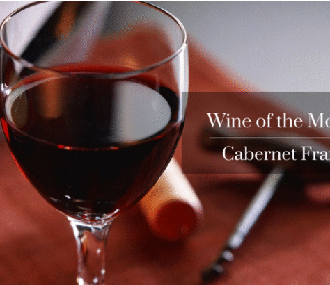 Close-up of a glass of red Cabernet Sauvignon wine with cork and opener.