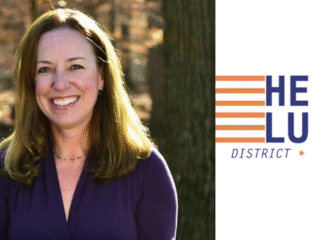 Smiling woman stands outdoors near a tree with a district logo beside her.