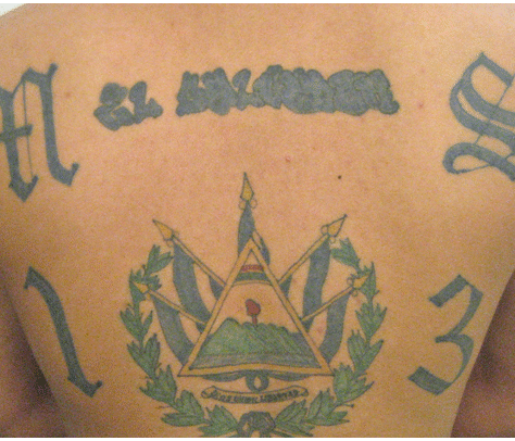 Tattoo of Guatemalan emblem with flags on skin.