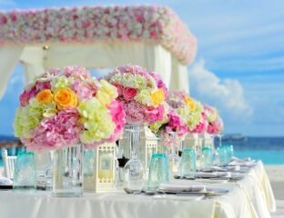 Elegant floral centerpiece arrangement at a beachside event.