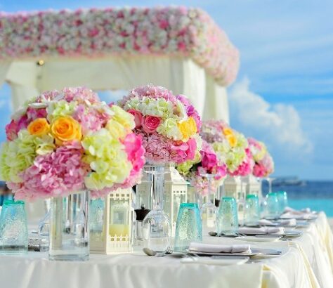Elegant floral centerpiece arrangement at a beachside event.