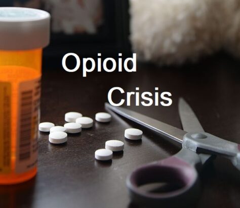 Scattered pills, scissors, and prescription bottle highlighting opioid crisis.
