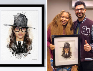 Two people holding a framed artistic portrait of a woman with glasses and a hat.