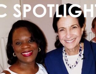 Two women smiling together in a close-up portrait.