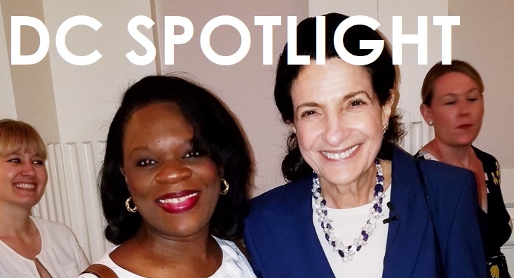 Two women smiling together in a close-up portrait.