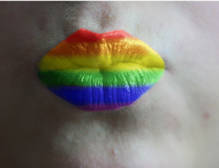 Lips painted with vibrant rainbow colors symbolizing LGBTQ+ pride.