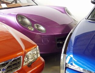Close-up of three colorful luxury sports cars parked side by side.