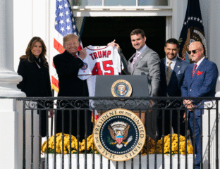 Donald Trump holding a jersey with the number 45 at the White House.