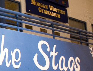 View of Morgan Wootten Gymnasium with 'The Stags' banner.