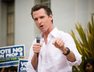 Man passionately speaking into a microphone outdoors.