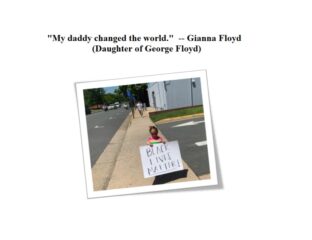 Child holding a sign that says 'My daddy changed the world.'