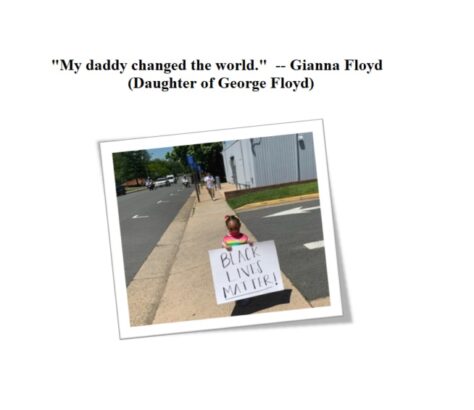 Child holding a sign that says 'My daddy changed the world.'