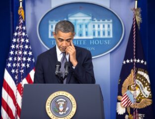 Barack Obama at a White House podium looking thoughtful.