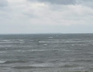 Choppy ocean waves under a cloudy sky.